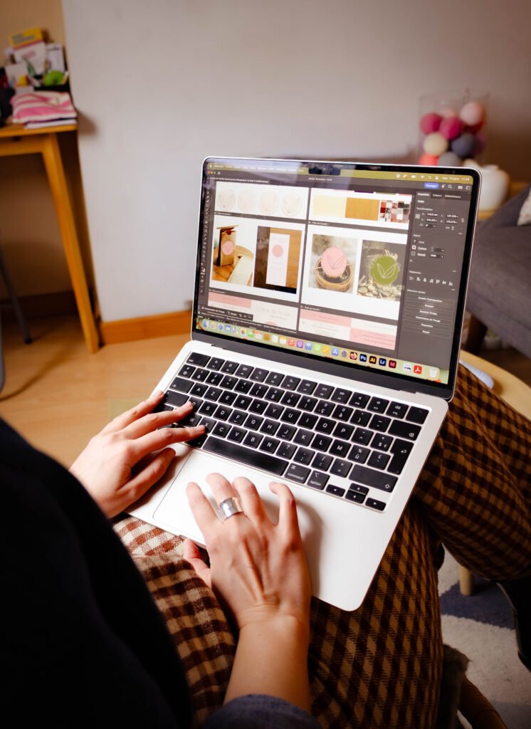 la fondatrice de Bonne Heure Studio, assise sur une chaise, on ne voit que ses mains sur son ordinateur. Sur l'écran de l'ordinateur, la création d'une identité visuelle